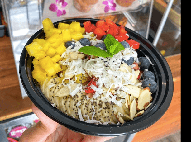 Açaí bowl topped with pineapple, banana, berries, coconut, and chia